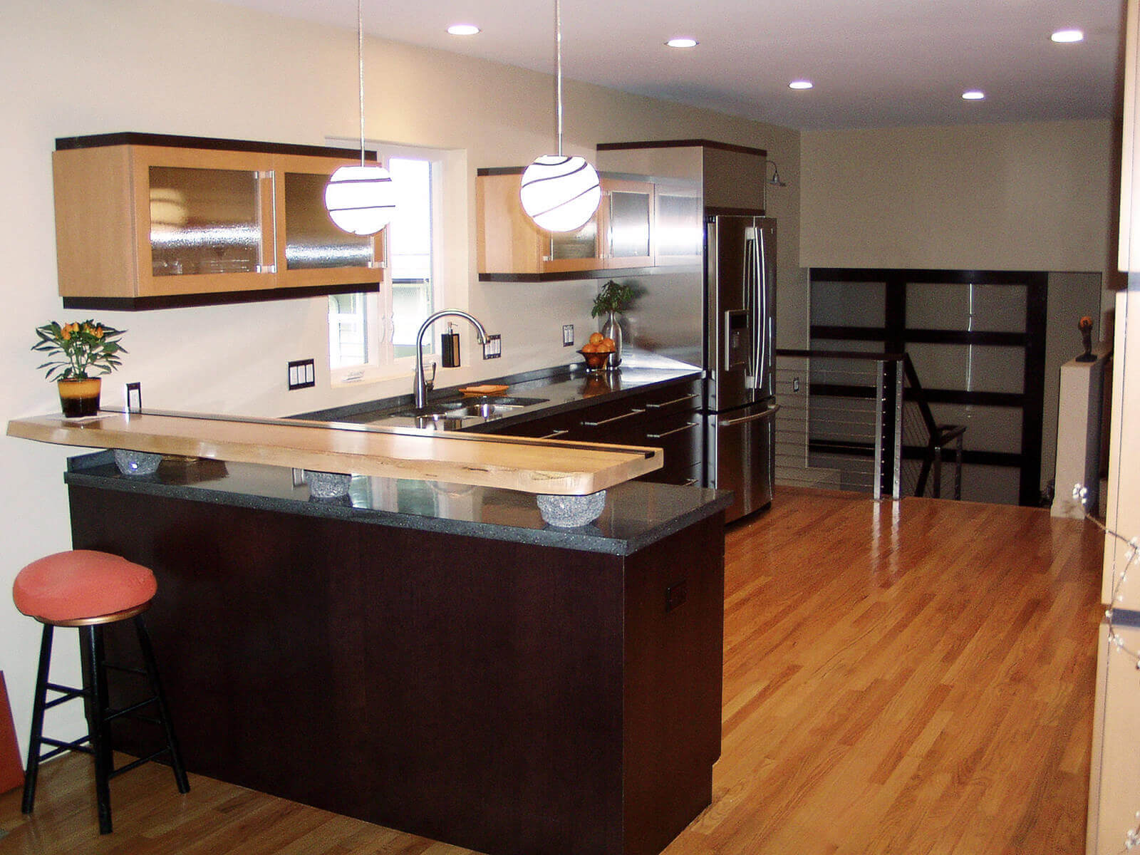 Modern custom cabinets and counter with raise hand-hewn and inlaid wood bar.