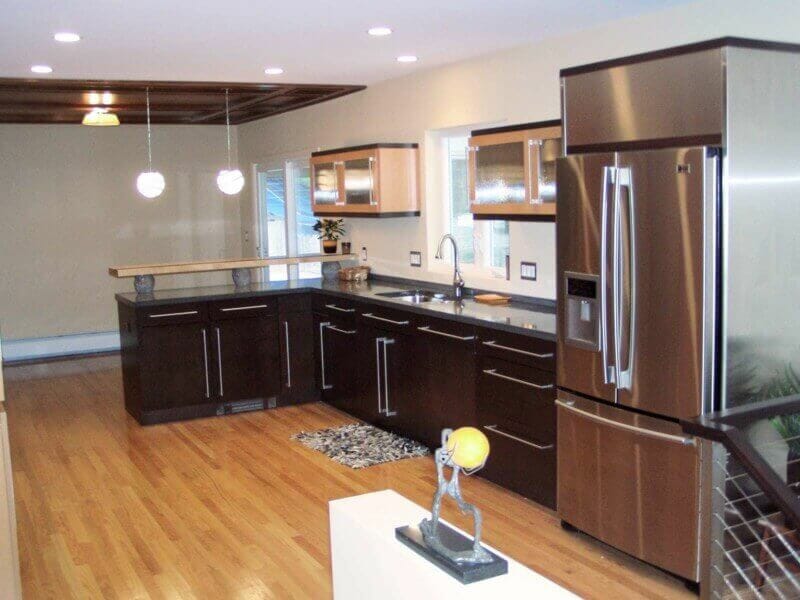 Long view of custom kitchen remodel with wooden inset dining area ceiling.