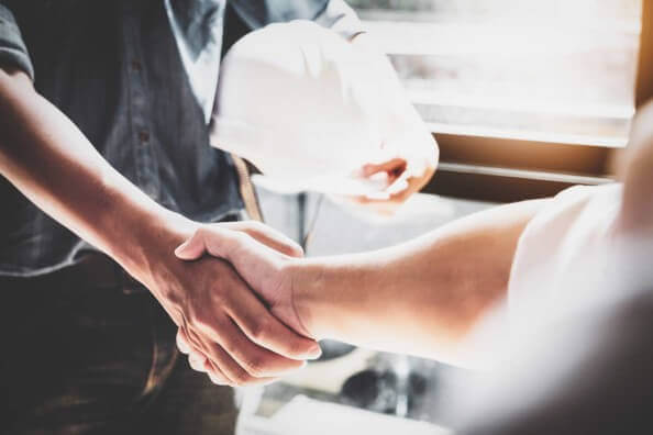 Handshake with hard hat. We hire workers with good values.